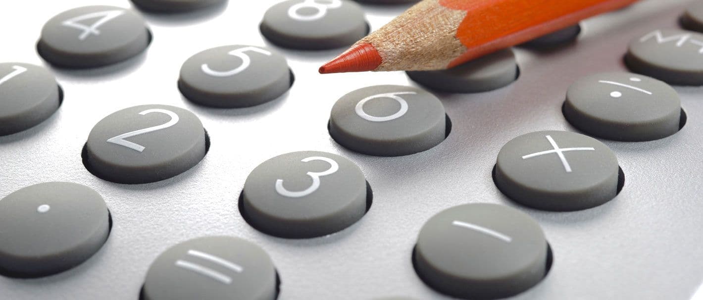 The picture shows buttons of a calculator and the top of a red pencil.