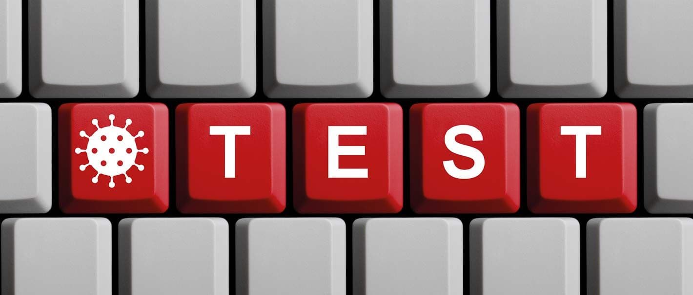 Computertastatur mit den Tasten „Test“ und einem Corona-Symbol